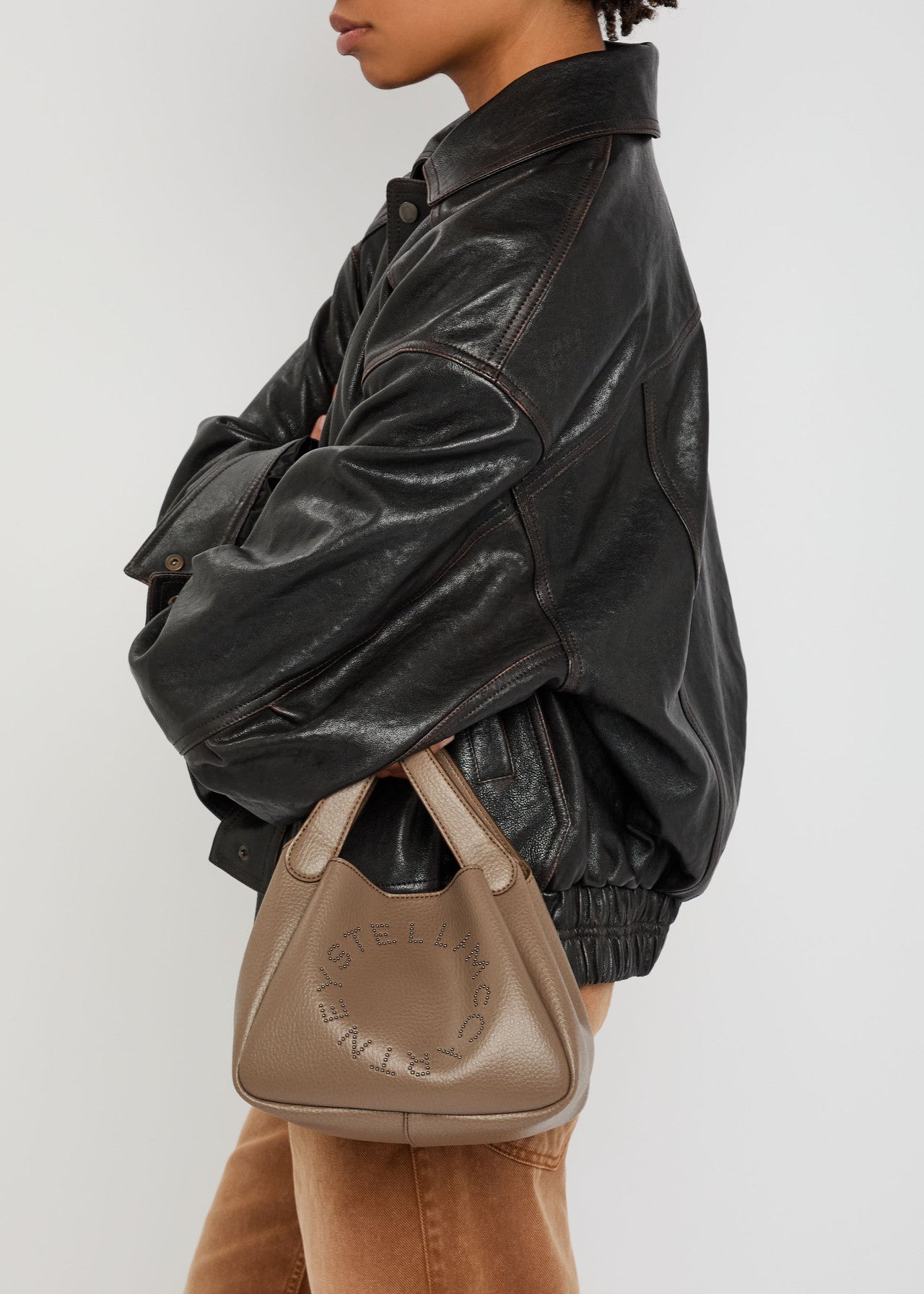 Logo studded faux leather top handle bag
