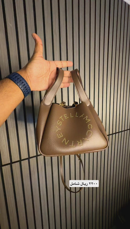 Logo studded faux leather top handle bag